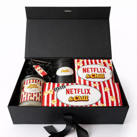 Gift set with 'Netflix & Chill' theme including a mug, popcorn container, and candy on a white background.