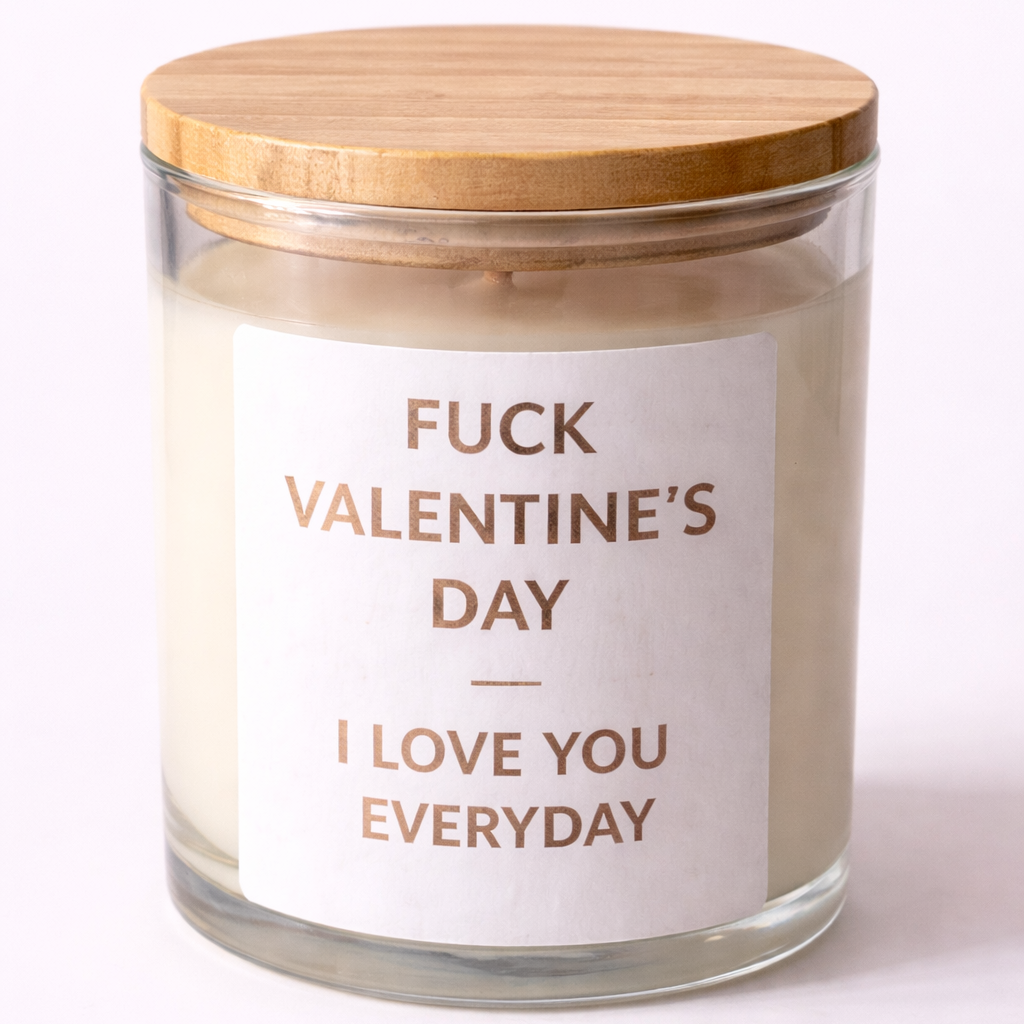 Candle in a glass jar with a wooden lid and a label reading 'Fuck Valentine's Day I Love You Everyday' on a white background.