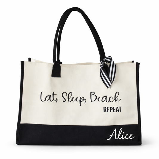 Beige tote bag with black text and trim, featuring a striped bow, on a white background.