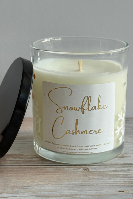 Candle with a label on a wooden surface