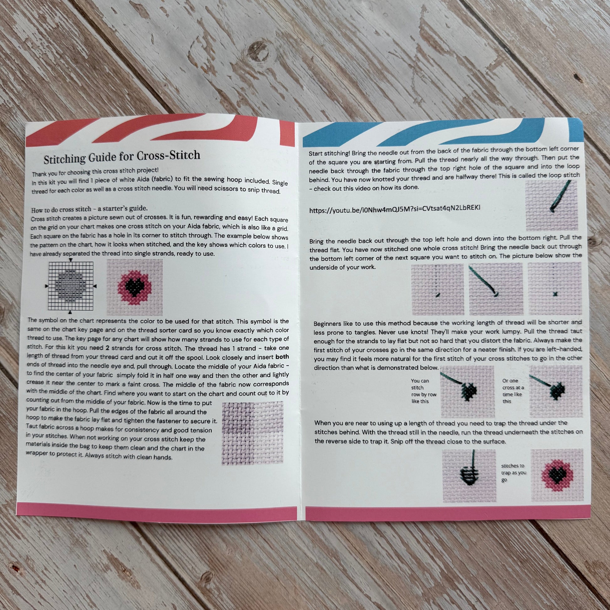Open book with text and patterns on a wooden surface