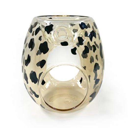 Glass candle holder with leopard print design on a white background