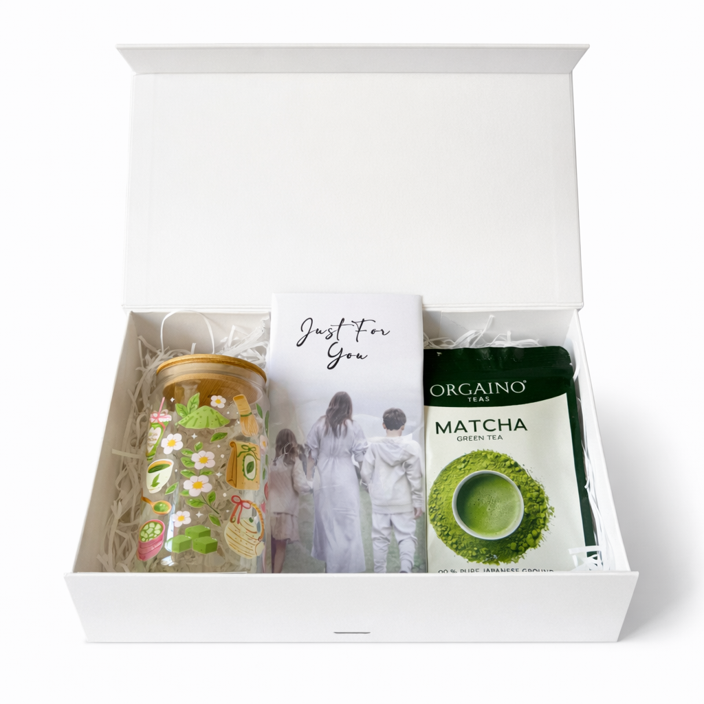 Gift set with a tumbler, tea bags, and a card in a white box.