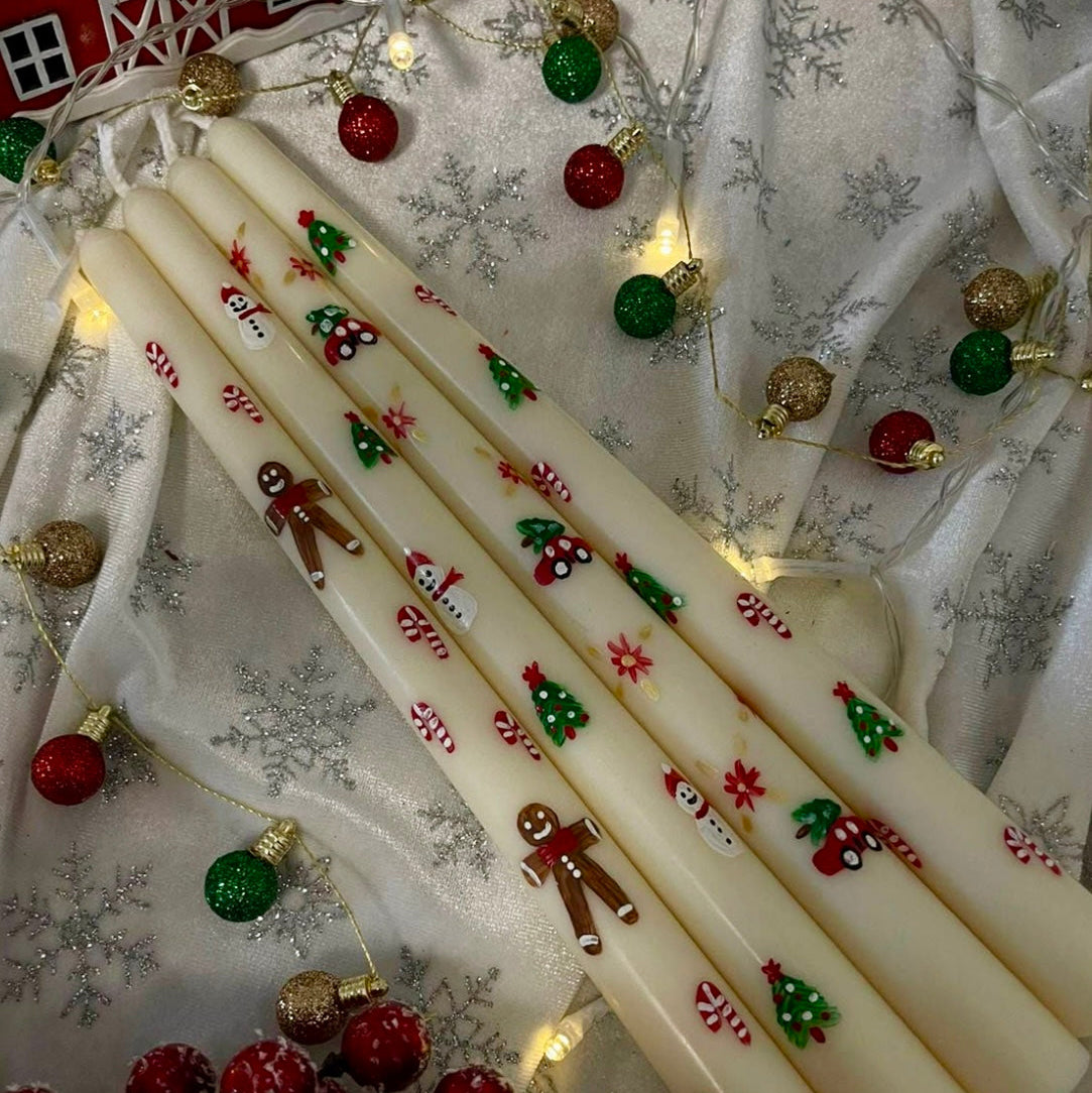 Decorative candles with Christmas designs on a festive background with lights and ornaments.