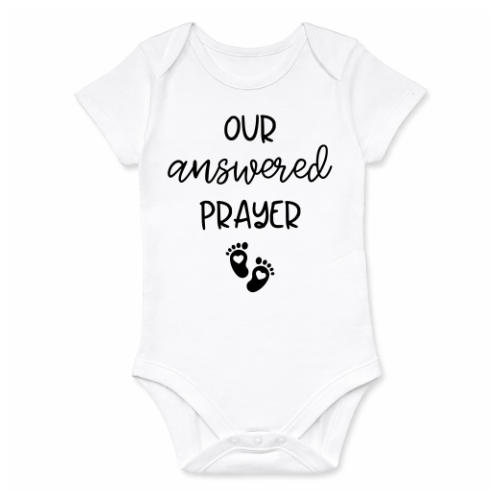 White baby onesie with 'Our answered prayer' text and footprints on a white background