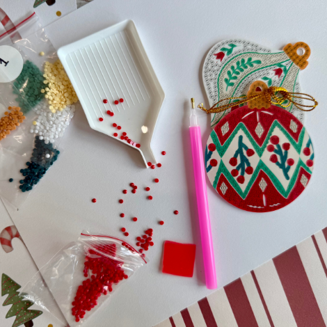 Crafting materials for making Christmas ornaments on a white surface