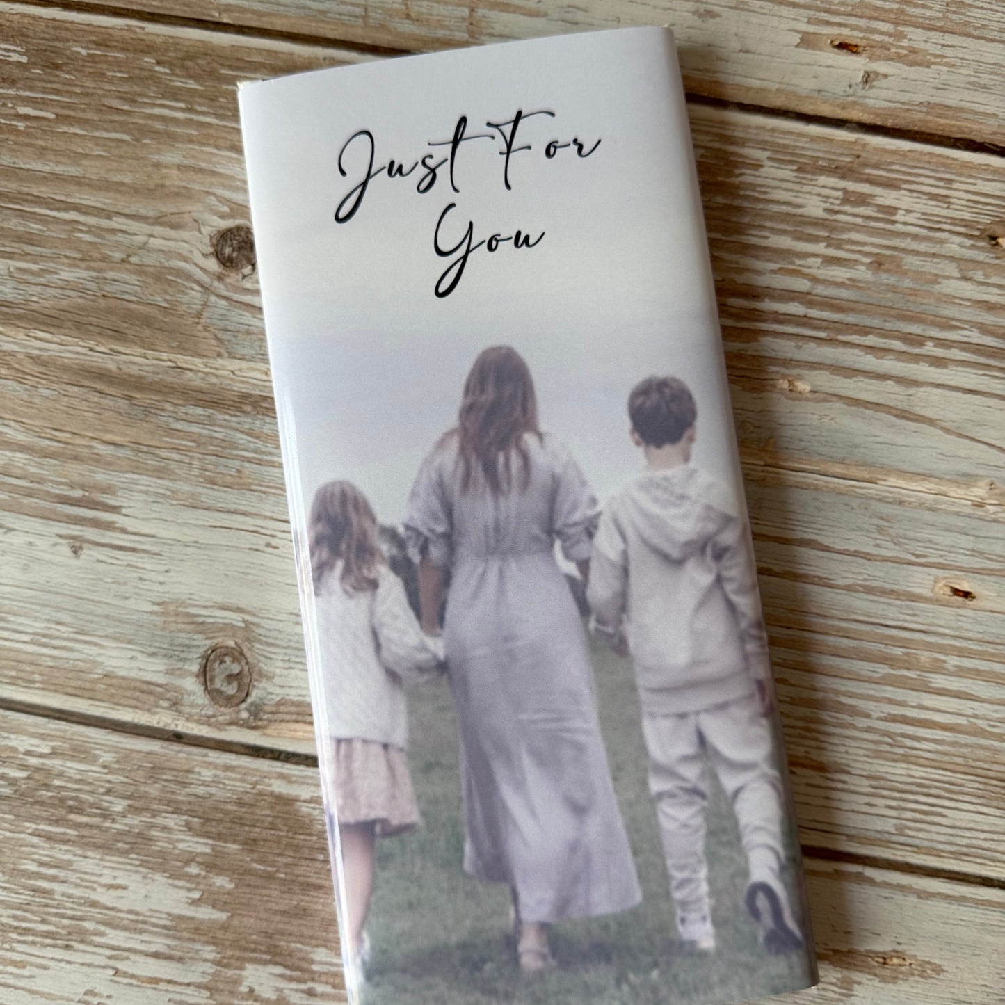 Notebook with a printed photo of two people on a wooden surface