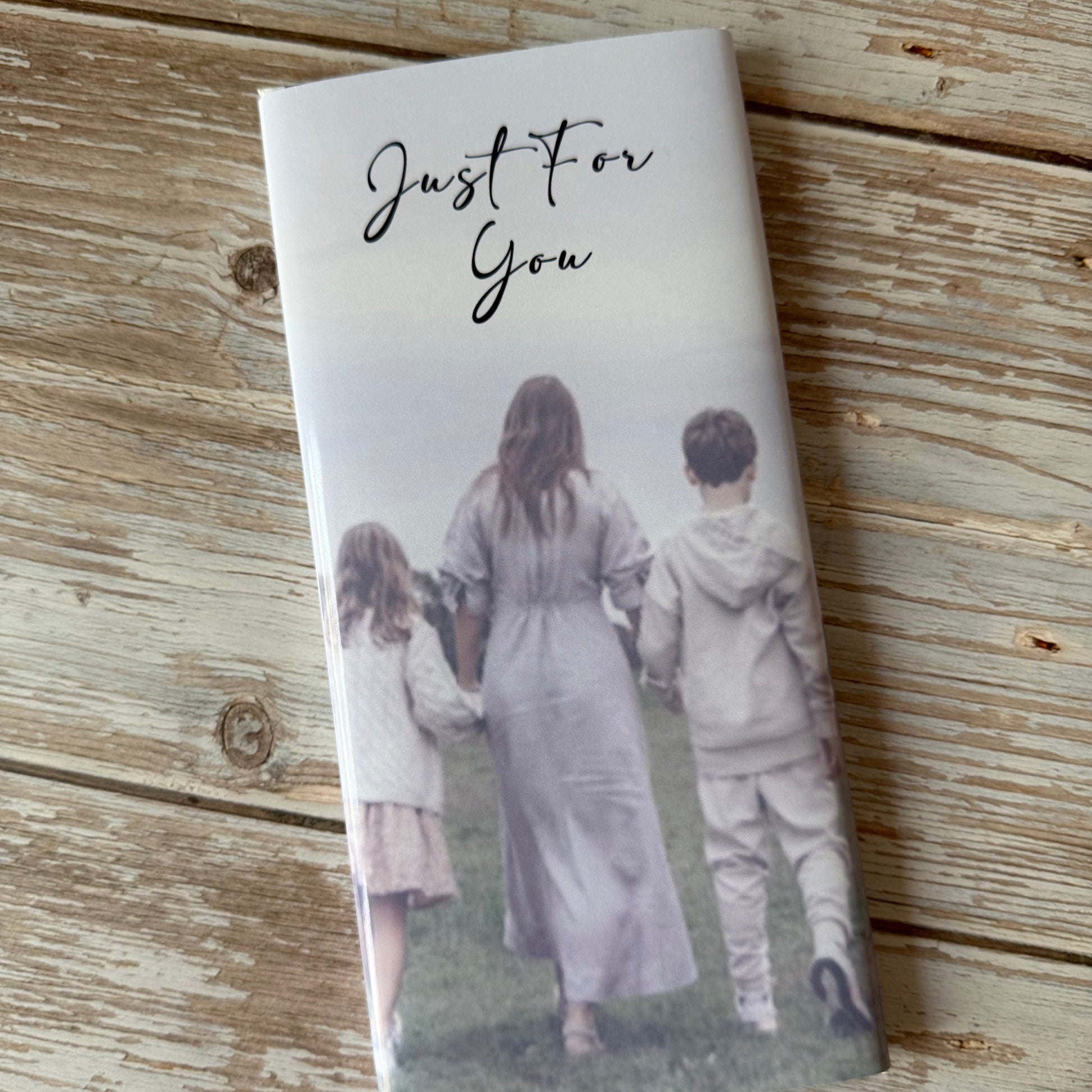 Notebook with a printed photo of two people on a wooden surface