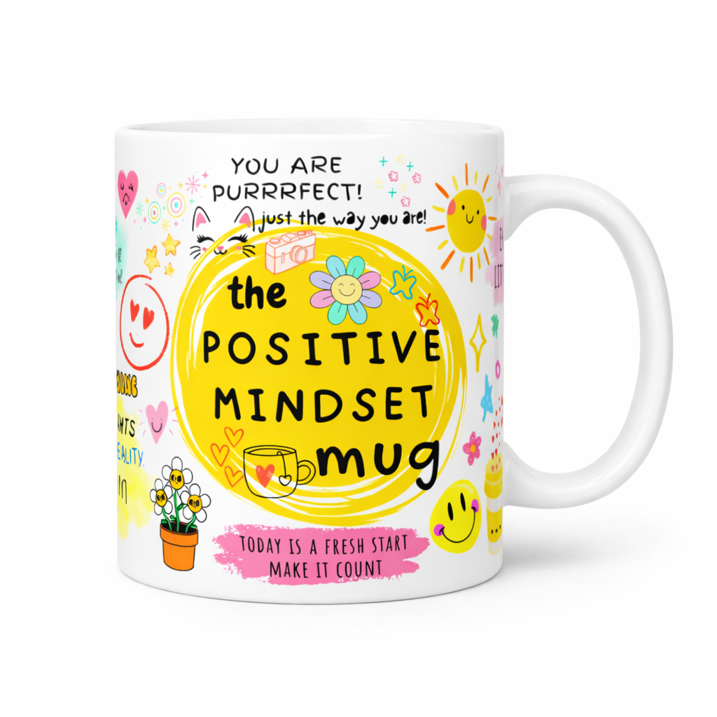 Colorful mug with motivational text and graphics on a light background